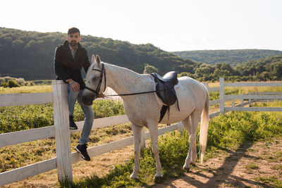 Full length of man riding horse