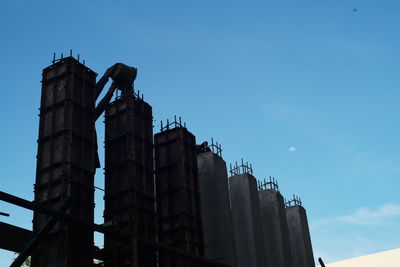 Low angle view of building against clear blue sky