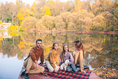 Family sitting by lake