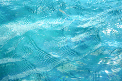 A photo of a clear wavy water scene with reflected sunlight makes the water shine, bali, indonesia