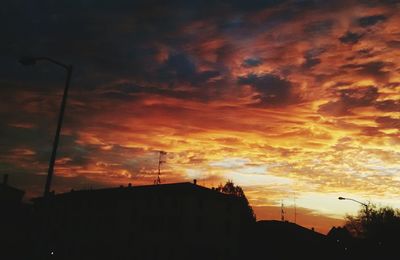 Silhouette of built structure against dramatic sky