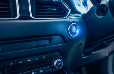 Start stop engine button of luxury car. push up button for start or stop car engine in keyless auto