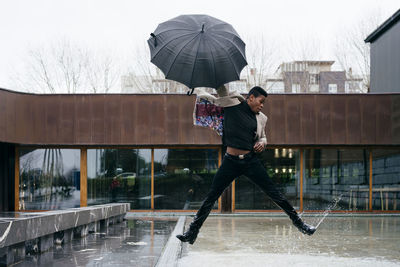 Full length of man on wet road during rainy season