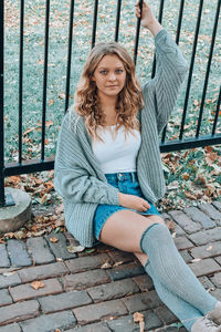 Portrait of young woman sitting outdoors