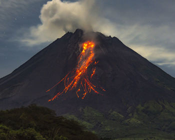 The splendor of mount merapi when it erupts at night