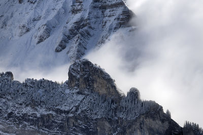 Low angle view of snowcapped mountain against sky