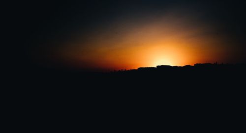 Scenic view of silhouette mountain against sky during sunset