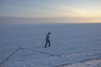 The boy is alone in the snow field