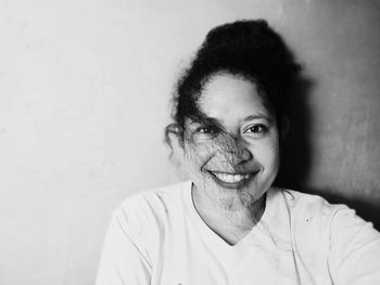 Portrait of smiling girl against wall