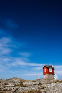 Low angle view of lighthouse against blue sky