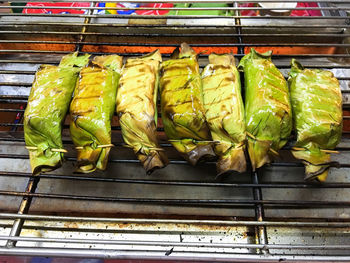 High angle view of food wrapped in leaves on barbecue