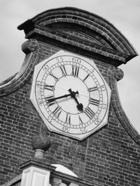 Low angle view of clock tower against building