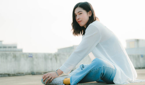 Young woman sitting outdoors