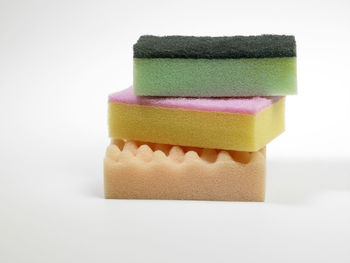 Close-up of multi colored sponges on white background