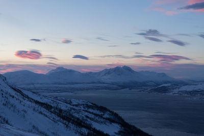 Idyllic shot of fjord with snowcapped mountains against sky