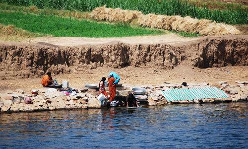 People sitting on riverbank