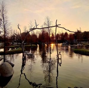 Scenic view of lake against sky at sunset