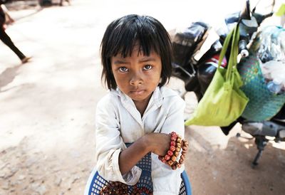 Portrait of girl selling bracelet