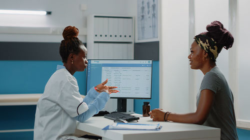 Doctor talking with patient at home