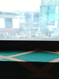 Close-up of glass window on table in city