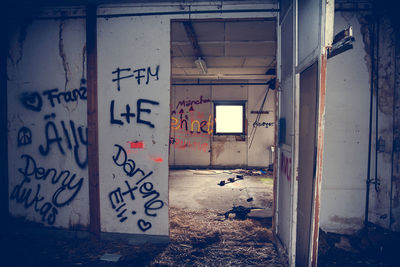 Graffiti on wall and door in abandoned building