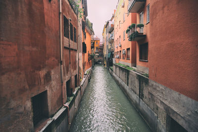 Canal amidst buildings in city