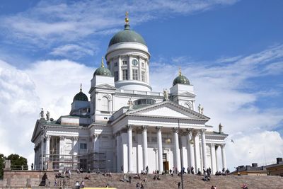 Low angle view of building against cloudy sky