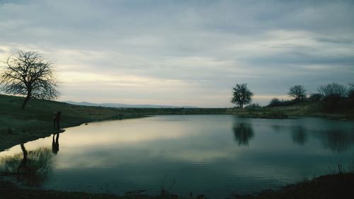 Scenic view of lake against sky at sunset