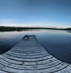 Pier over lake against sky