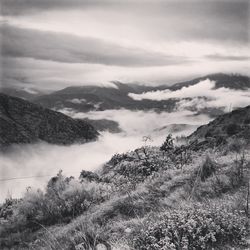 Scenic view of mountains against cloudy sky