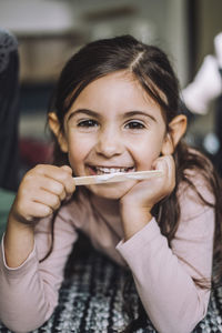 Portrait of smiling girl eating ice cream at day care center