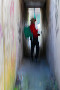 Full length of man standing in red mirror