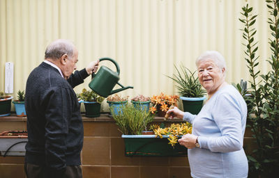 Senior couple gardening on balcony