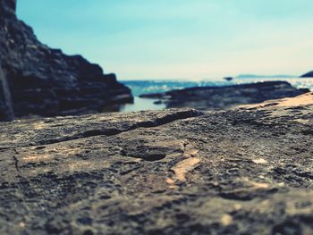 Close-up of rocks on beach against sky