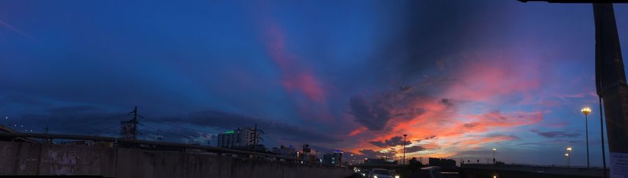 Low angle view of illuminated buildings against sky at sunset