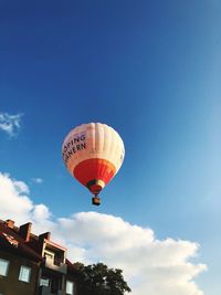 Low angle view of hot air balloon against blue sky