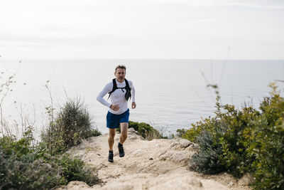 Full length of man on sea shore against sky