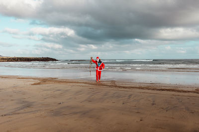 Man standing on beach against sky