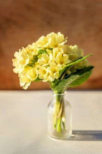 Close-up of yellow flower vase on table