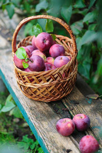Ripe red apples in a basket outdoor