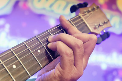 Cropped hand playing guitar 