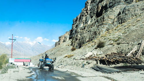 Vehicles on road against mountain range