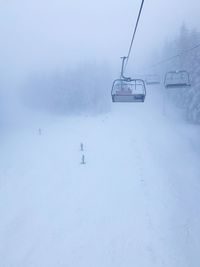 Overhead cable car on snow covered field