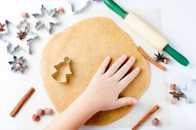 Cropped hand of woman holding heart shape on table