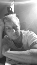 Close-up portrait of young woman at home