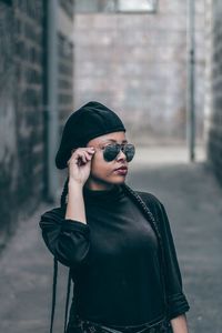 Young woman wearing sunglasses standing outdoors