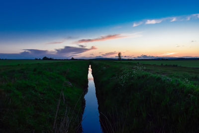 Scenic view of field against sky during sunset
