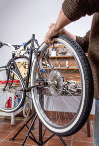 Midsection of man holding bicycle