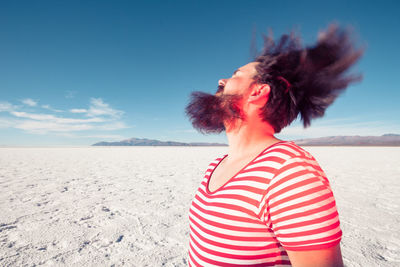 Full length of woman on beach against sky