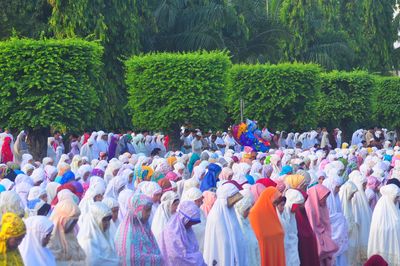 Group of people in traditional clothing a pray ied fitr